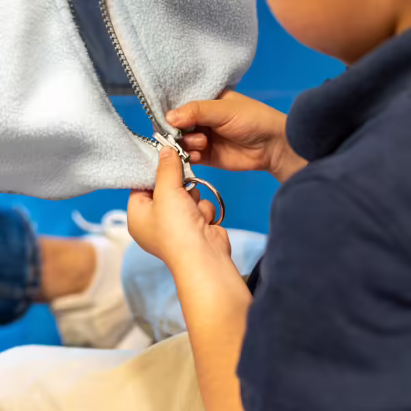 little hands figuring out a zipper